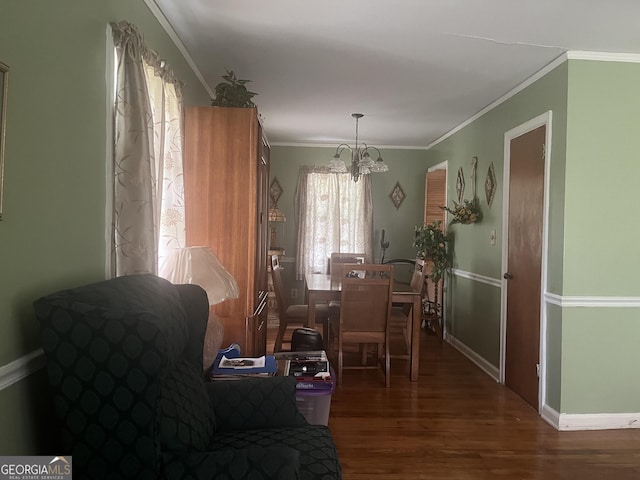 dining space with dark hardwood / wood-style flooring, a chandelier, and ornamental molding