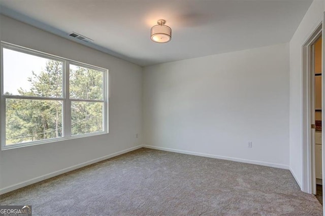 unfurnished room with light colored carpet