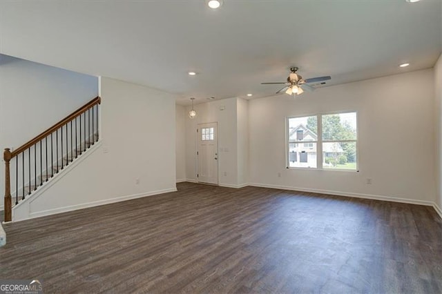 unfurnished living room featuring ceiling fan and dark hardwood / wood-style floors