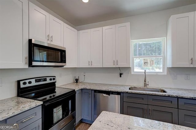 kitchen with sink, white cabinetry, and appliances with stainless steel finishes