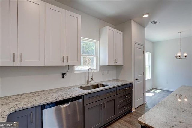 kitchen featuring sink, decorative light fixtures, white cabinetry, dishwasher, and light stone countertops