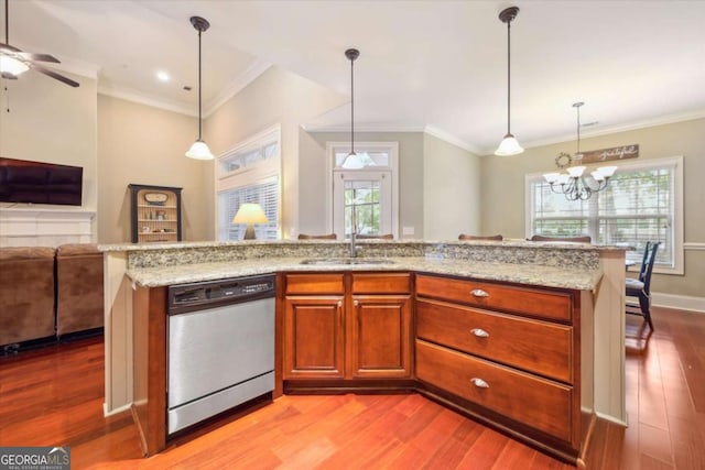 kitchen with dishwasher, crown molding, sink, and decorative light fixtures