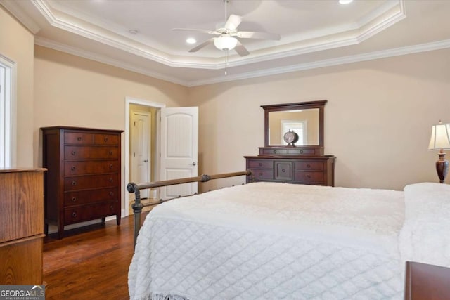 bedroom featuring dark hardwood / wood-style flooring, a raised ceiling, ceiling fan, and crown molding