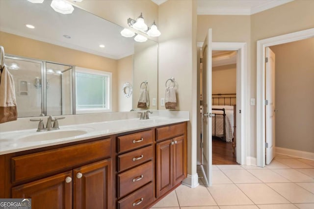 bathroom featuring tile patterned floors, crown molding, a shower with door, and vanity