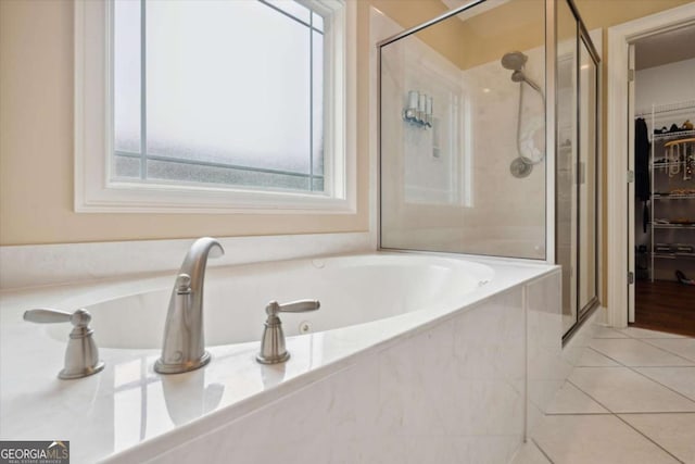 bathroom featuring separate shower and tub and tile patterned flooring