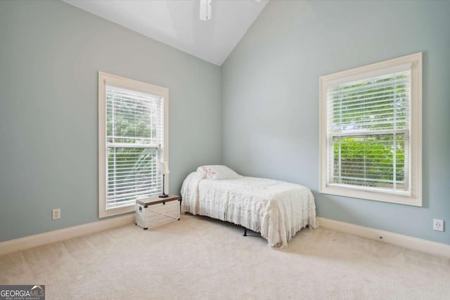 carpeted bedroom with vaulted ceiling and ceiling fan