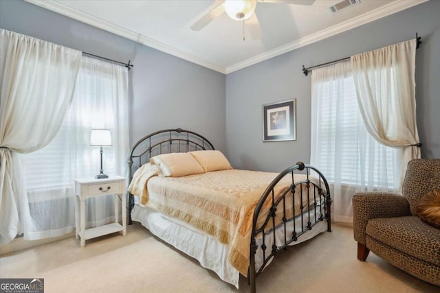 bedroom with carpet flooring, ceiling fan, crown molding, and multiple windows