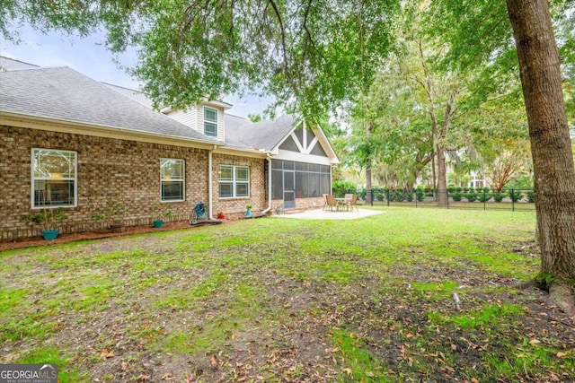 view of yard with a sunroom and a patio