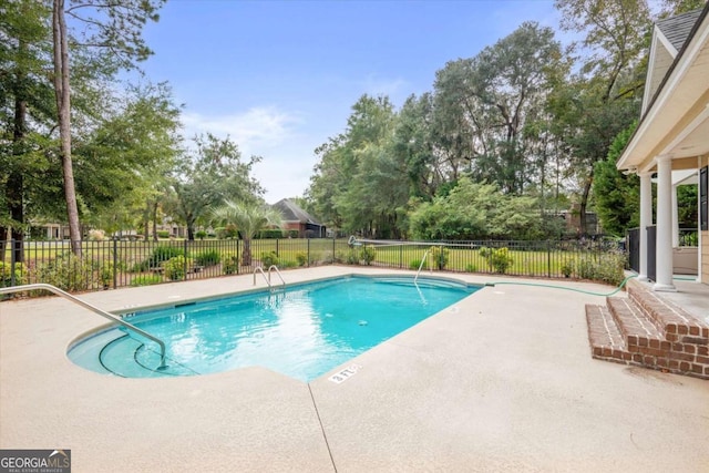 view of swimming pool featuring a patio area