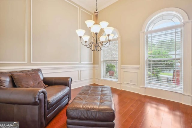 sitting room with dark hardwood / wood-style floors and a notable chandelier