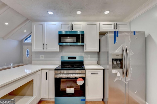 kitchen featuring white cabinets, a textured ceiling, and appliances with stainless steel finishes