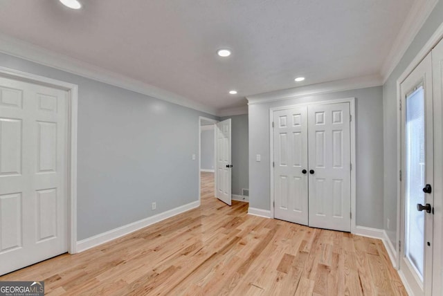 unfurnished bedroom featuring multiple windows, crown molding, and light hardwood / wood-style floors