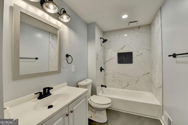 full bathroom featuring vanity, tiled shower / bath combo, and toilet