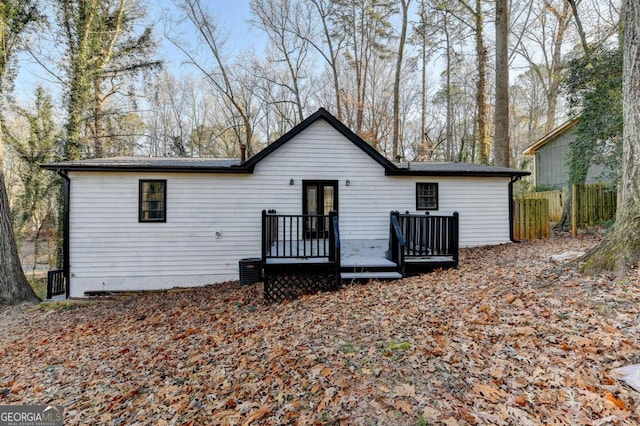 back of property with a wooden deck