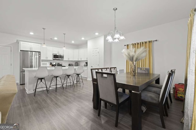 dining area featuring a chandelier and dark hardwood / wood-style floors