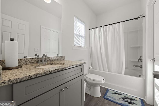 full bathroom featuring hardwood / wood-style flooring, vanity, toilet, and shower / bath combo