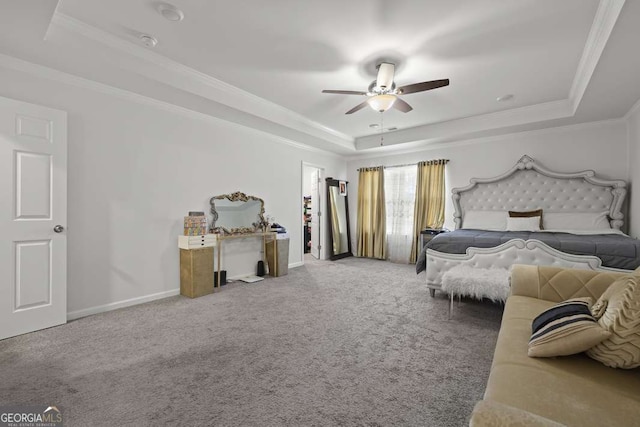 carpeted bedroom featuring a tray ceiling, ceiling fan, and ornamental molding