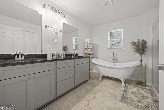 bathroom featuring vanity and a tub to relax in