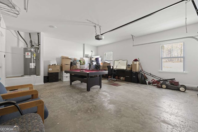 garage with a garage door opener and water heater