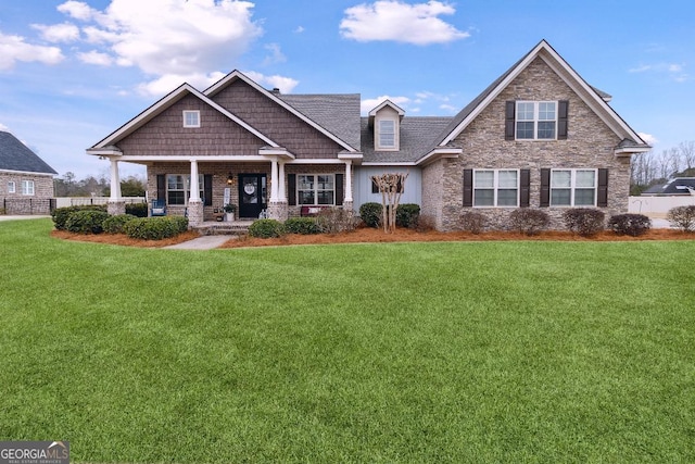 craftsman-style home featuring a front lawn and covered porch