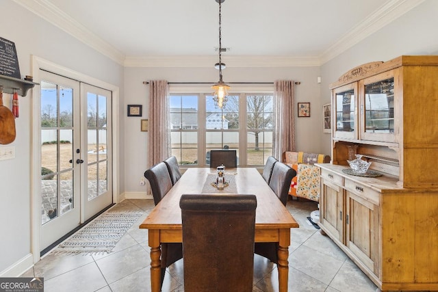 tiled dining area featuring ornamental molding and french doors