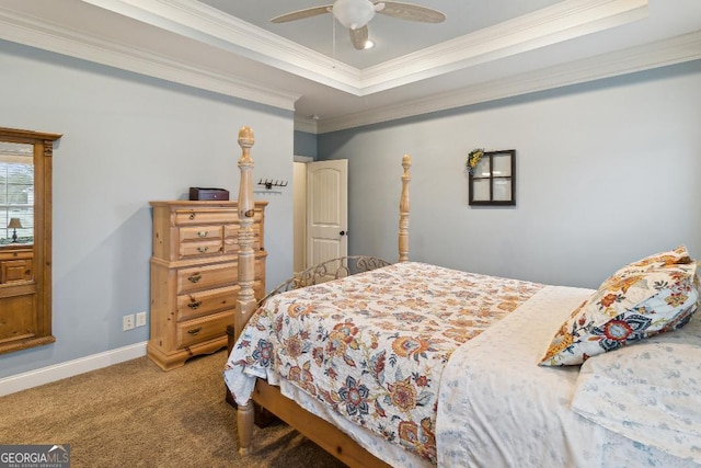 bedroom featuring ceiling fan, a tray ceiling, carpet floors, and ornamental molding