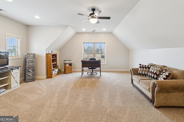 carpeted home office featuring ceiling fan, vaulted ceiling, and plenty of natural light