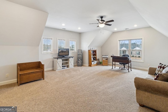 interior space featuring ceiling fan, vaulted ceiling, and carpet flooring