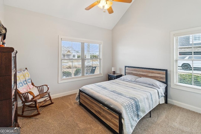 bedroom with ceiling fan, carpet, lofted ceiling, and multiple windows