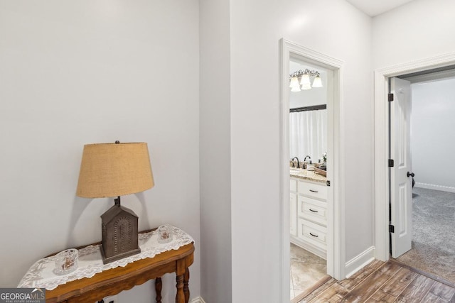 hallway with light hardwood / wood-style floors