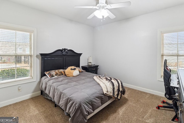 bedroom with ceiling fan, multiple windows, and carpet floors