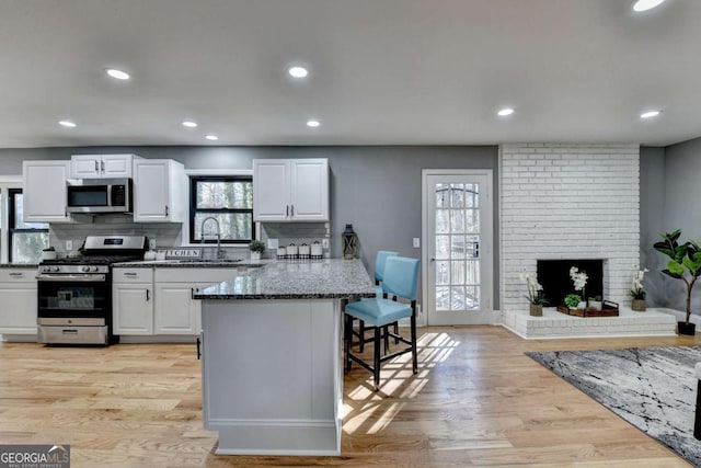 kitchen featuring tasteful backsplash, white cabinets, and stainless steel appliances