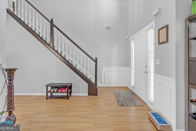 dining area featuring wood-type flooring and crown molding