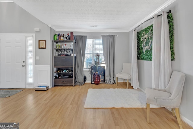 unfurnished room with hardwood / wood-style floors and a textured ceiling