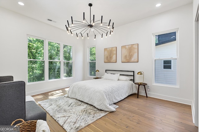 bedroom with a chandelier and hardwood / wood-style flooring