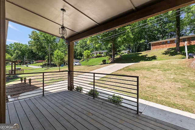 wooden terrace featuring a yard