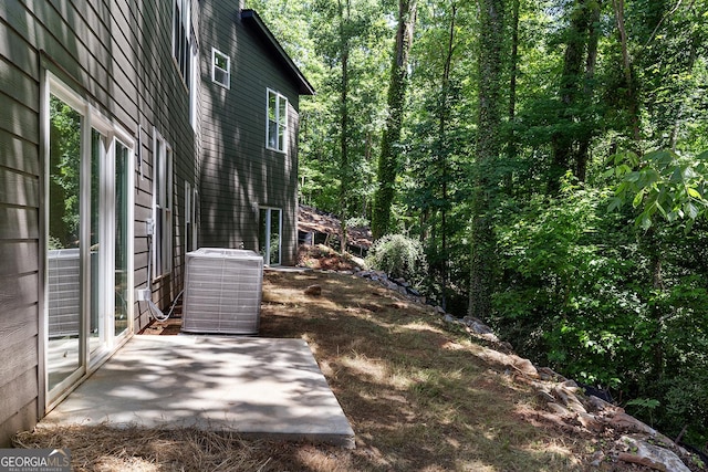 view of home's exterior with central air condition unit and a patio area