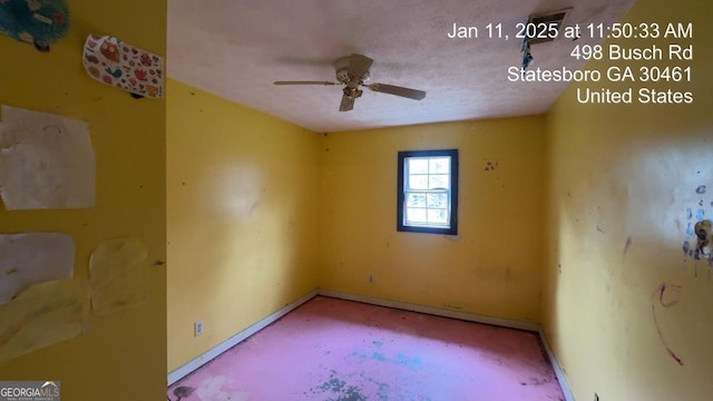 unfurnished room with ceiling fan and a textured ceiling