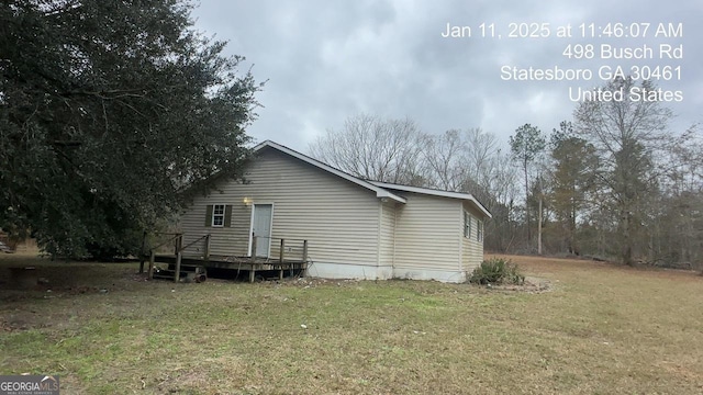 back of house with a yard and a deck