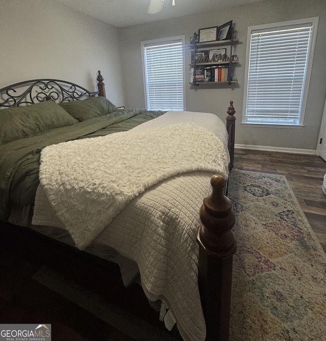 bedroom with ceiling fan and dark hardwood / wood-style floors