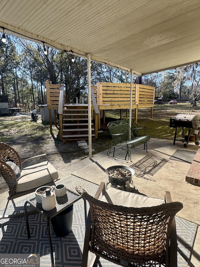 view of patio with a grill and an outdoor fire pit