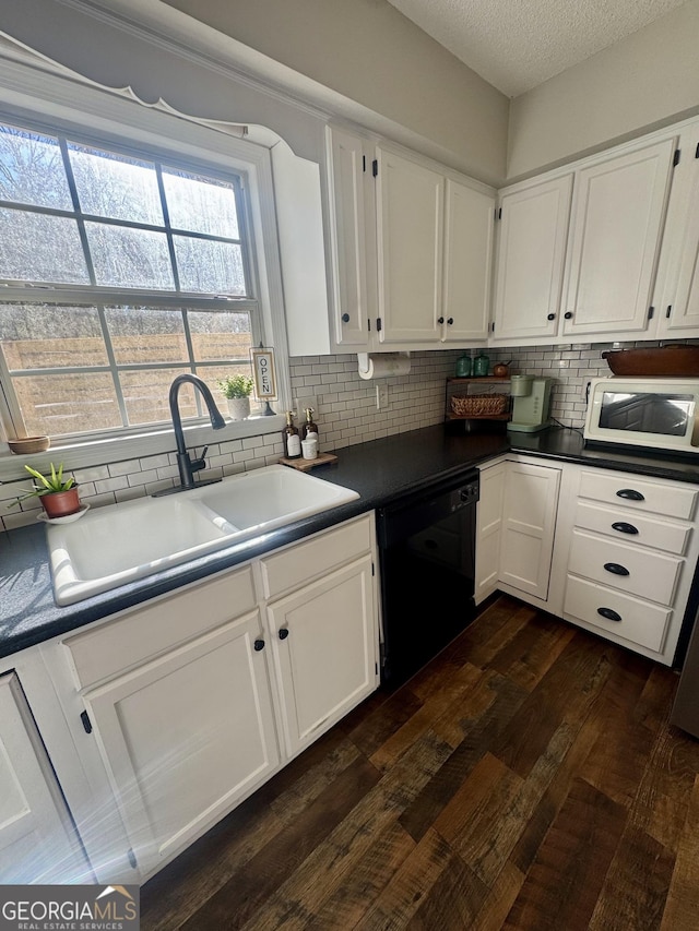 kitchen with sink, white cabinetry, and black dishwasher