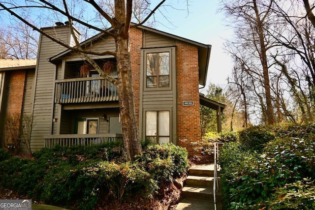 back of property featuring a balcony