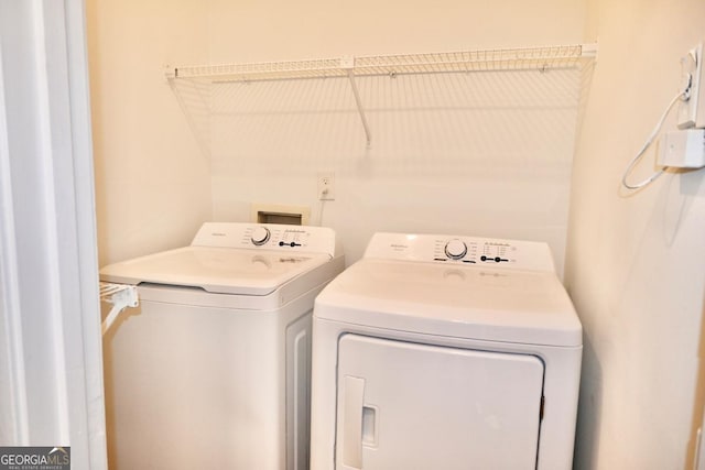 washroom featuring washer and clothes dryer