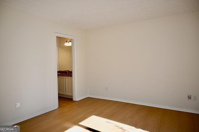 empty room with light hardwood / wood-style floors and sink