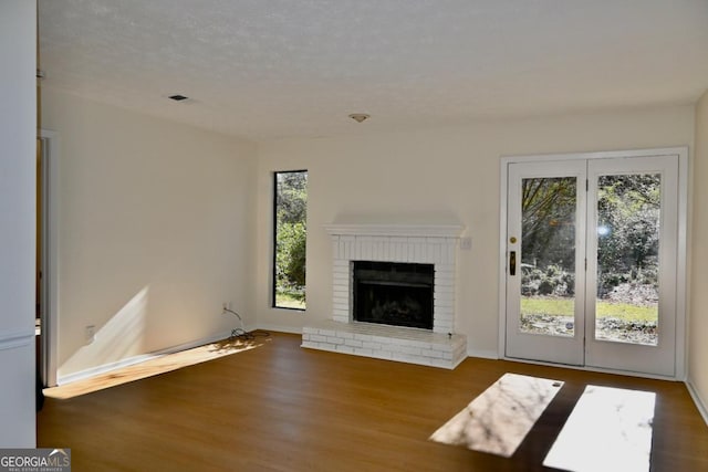 unfurnished living room with dark hardwood / wood-style floors and a fireplace