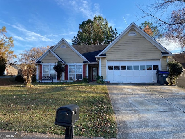 view of front of home with a front yard and a garage