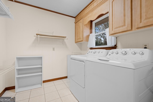 washroom featuring cabinets, independent washer and dryer, crown molding, and light tile patterned flooring