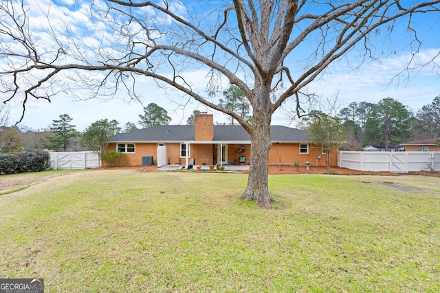 back of property featuring a lawn, a patio, and central AC