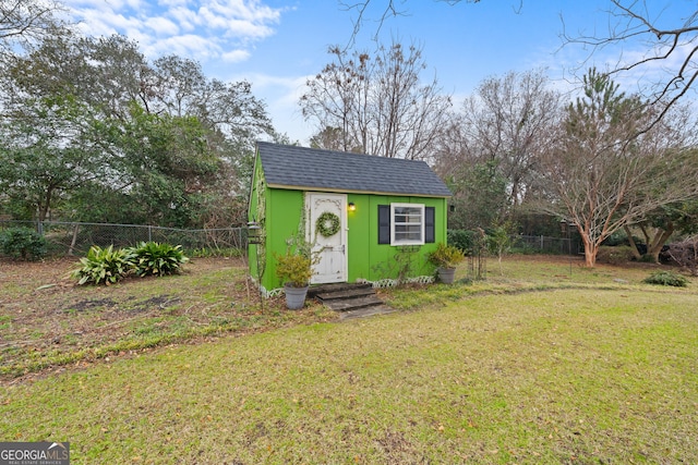 view of outbuilding with a lawn